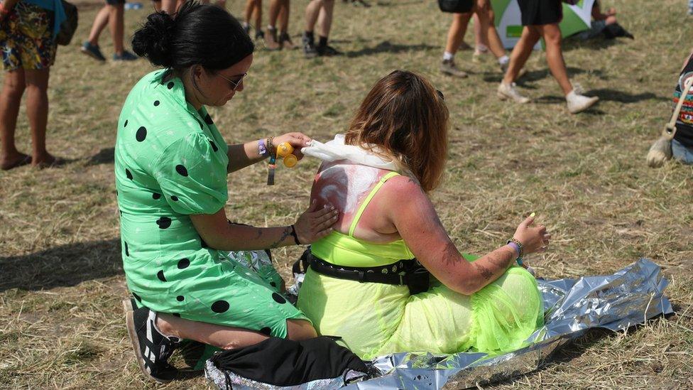 People apply suncream at Glastonbury