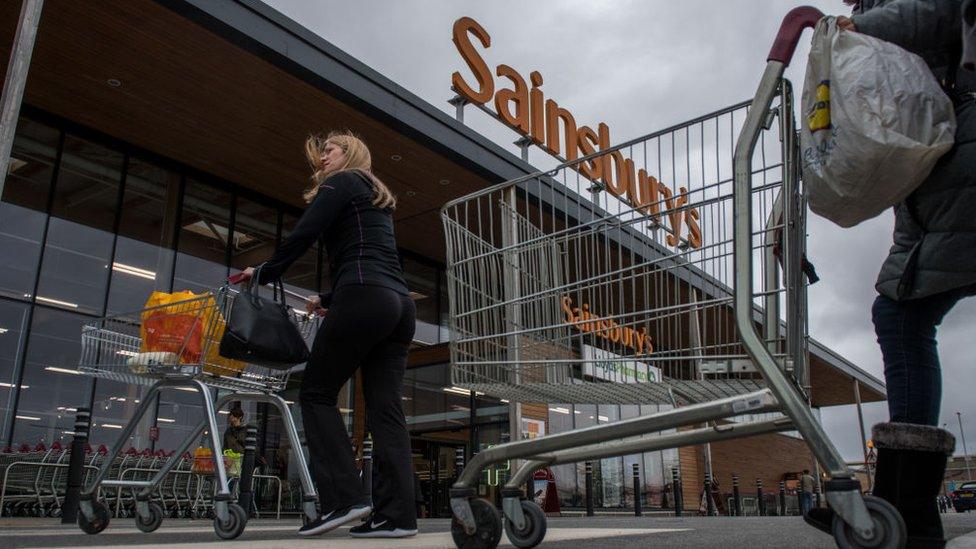 People walk into Sainsbury's store