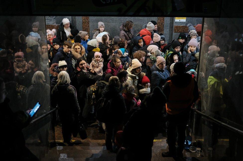 Women and children queue at Lviv station for a train to Poland. Tens of thousands are passing through the station every day