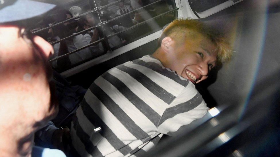 Satoshi Uematsu, suspected of a deadly attack at a facility for the disabled, is seen inside a police car as he is taken to prosecutors, at Tsukui police station in Sagamihara, Kanagawa prefecture, Japan, in this photo taken by Kyodo July 27, 2016.