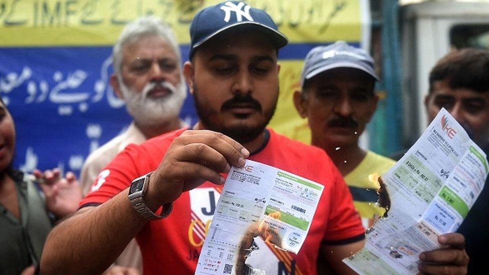 A trader in Karachi sets electricity bills on fire