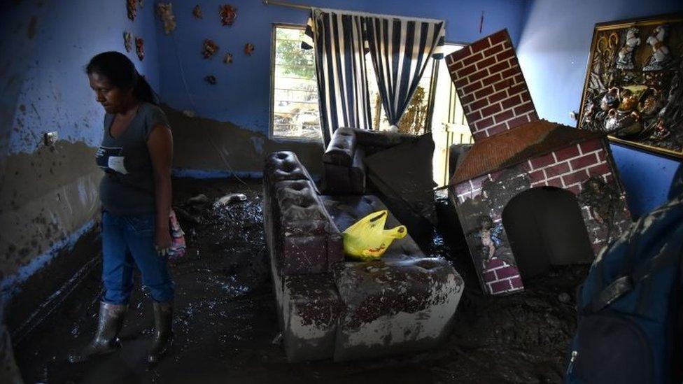 A woman observes her house after a flooding of La Paila river in the municipality of Corinto, Department of Cauca, Colombia, 08 November 2017.