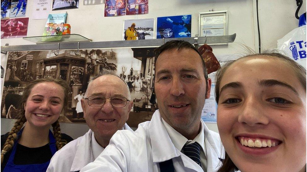 Four staff members working at the butchers