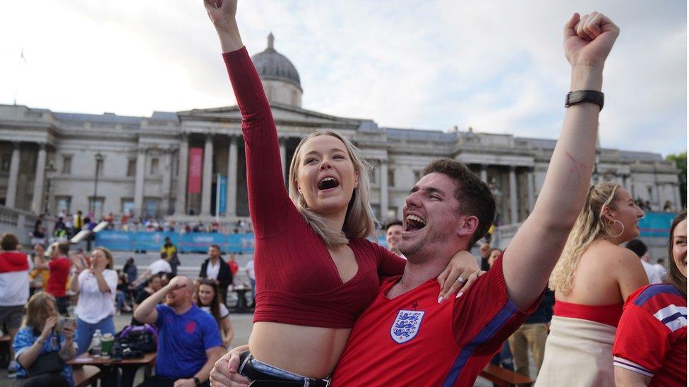 Fans in Trafalgar Square, London, celebrate Harry Kane"s first goal as they watch the Euro2020 quarter final match between England and the Ukraine.