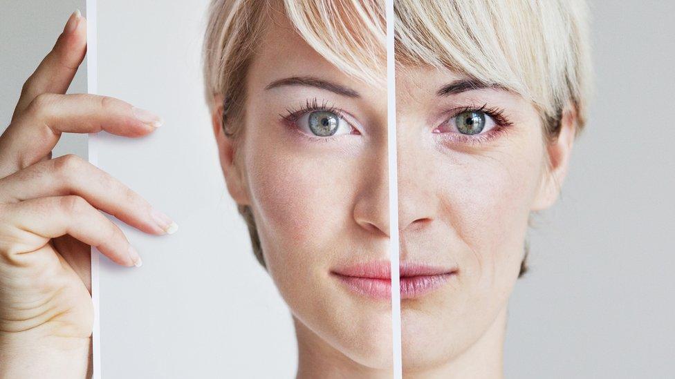 Woman holding up a retouched photo