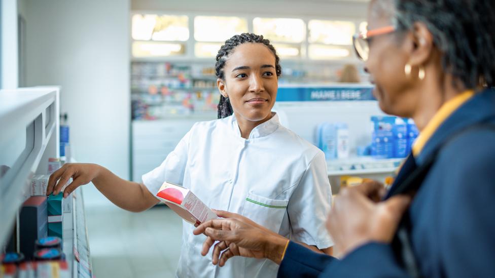 Pharmacist assisting a customer