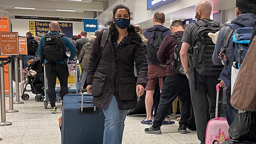 Passengers queue for check in at Manchester Airport's terminal 1 on 4 April 2022