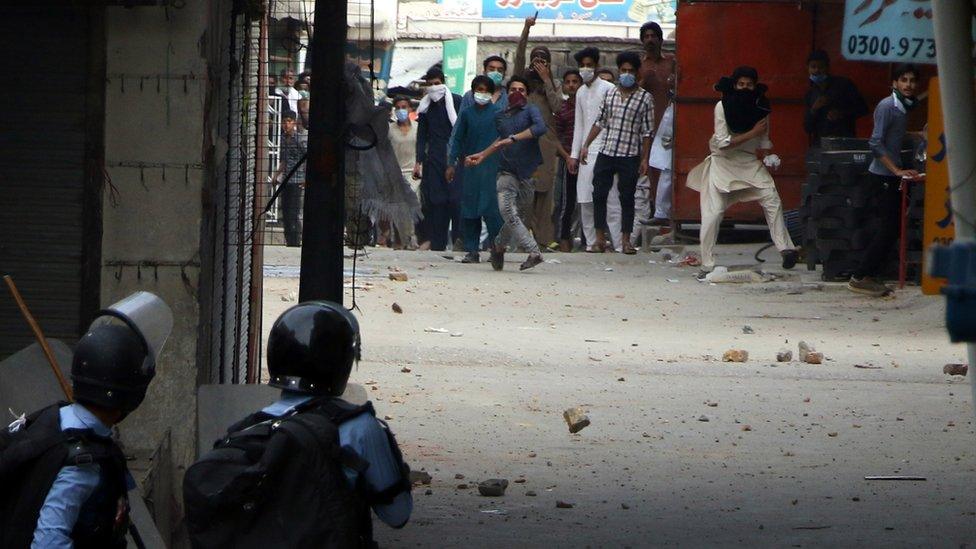 Police clash with supporters of Islamic political party Tehreek-e-Labbaik Pakistan (TLP), after they blocked a road to demand the release of their leader Saad Hussain Rizvi, in Islamabad, Pakistan, 13 April 2021.