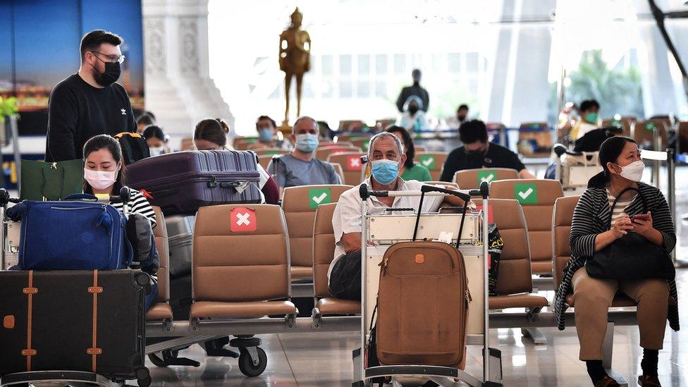 Tourists in arrivals area