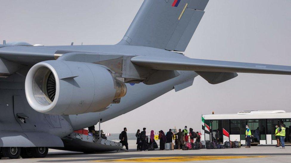 Afghans disembark a C-17 in the UAE