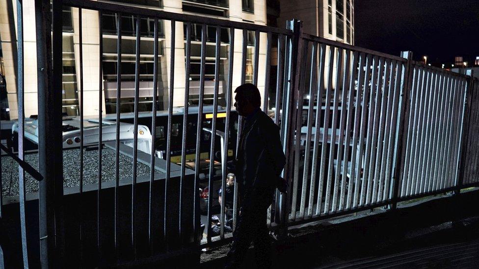 A relative of a detained soldier, accused of participating on the July 15 attempted coup, stands outside the gates of the Istanbul courthouse (20 July)