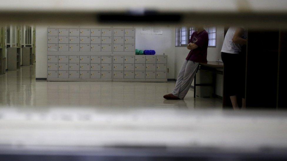 A detainee seen through a hatch at a Tokyo immigration centre