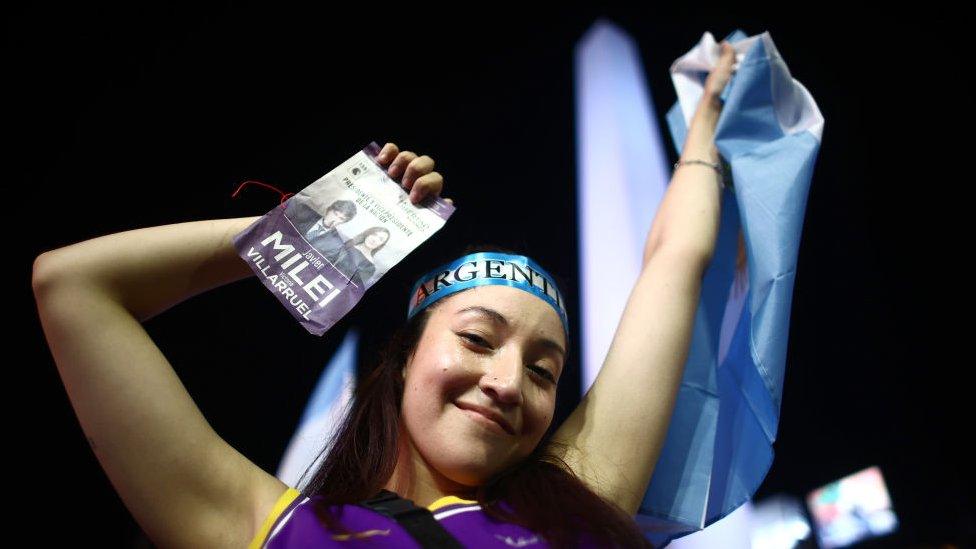 A supporter of newly elected President of Argentina Javier Milei of La Libertad Avanza celebrates after the polls closed in the presidential runoff on November 19, 2023 in Buenos Aires, Argentina.