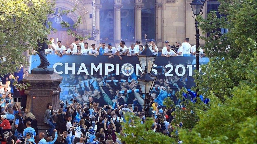 Manchester City players on a open-top bus