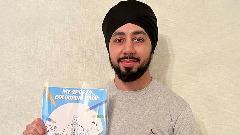 Avi Jandu holding colouring book