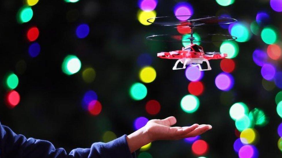 A boy plays with a "My First Drone"