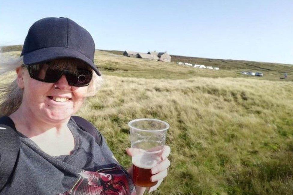 Wendy Clarke with a pint outside