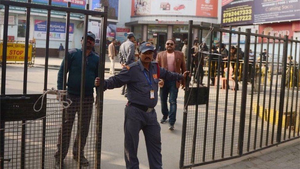 An Indian security guard stands outside a cinema, which is not screening Bollywood film "Padmaavat" due to threats of violence by Hindu hardliners, in Allahabad on January 25, 2018.