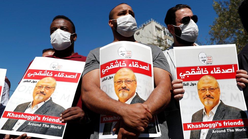 Men hold up posters of Saudi journalist Jamal Khashoggi on the second anniversary of his killing, outside the Saudi consulate in Istanbul, Turkey (2 October 2020)