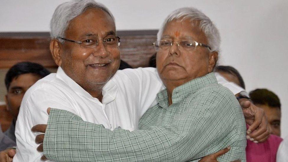 Nitish Kumar (L), a leader of Janata Dal (United) and Chief Minister of eastern state of Bihar, hugs Lalu Prasad Yadav, chief of Rashtriya Janata Dal, before addressing a news conference in Patna