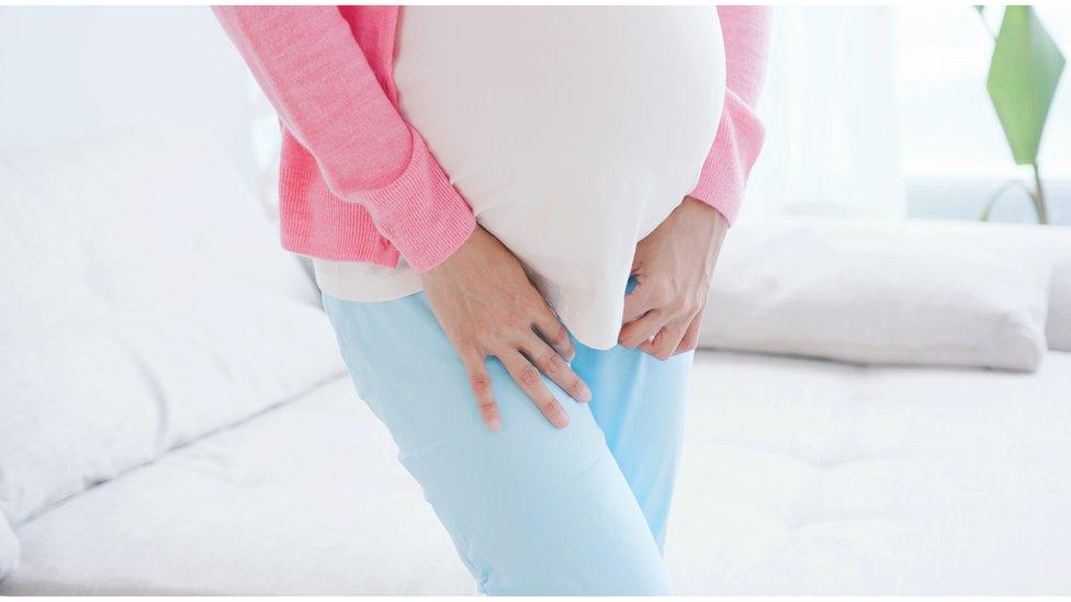 A stock image of a pregnant women with a toilet emergency