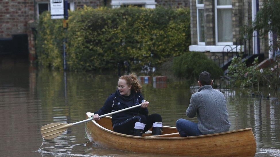 Couple canoeing from their home