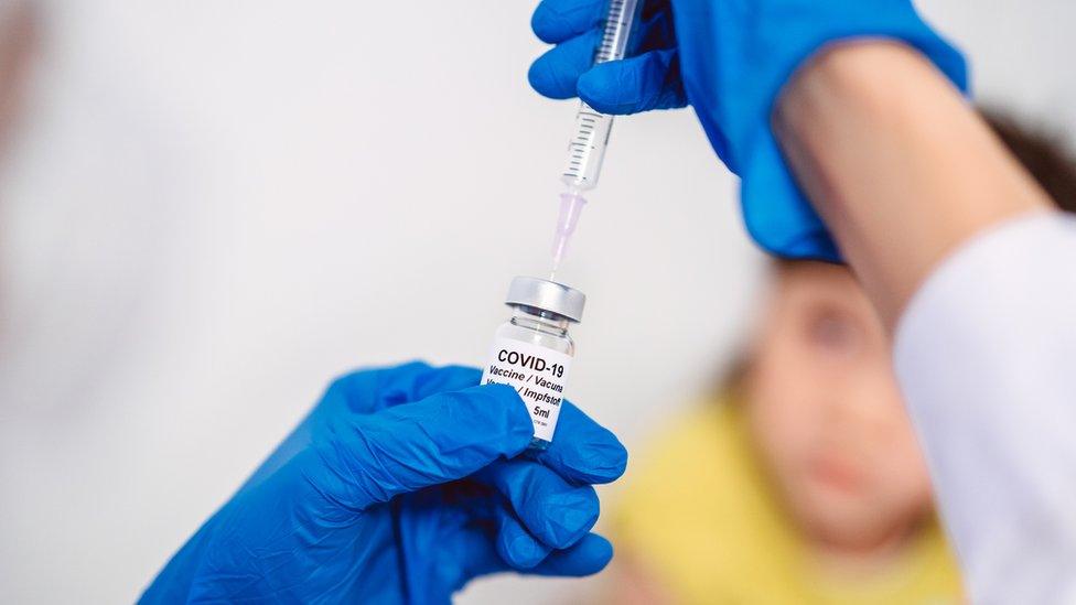 A health professional preparing a Covid-19 vaccine