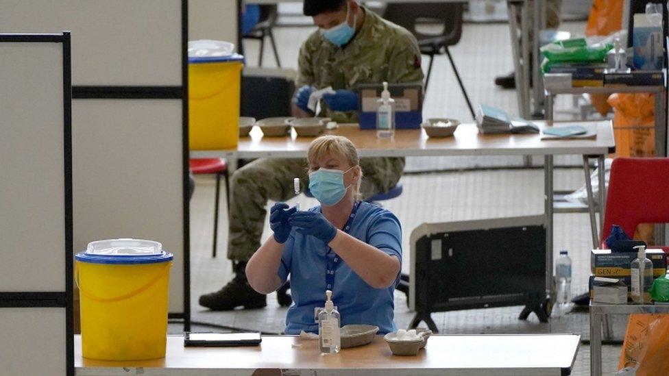 A nurse with a vial of vaccine at the vaccination centre at Ravenscraig Regional Sports Facility in Motherwell