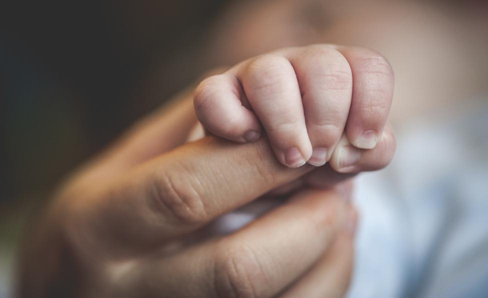 detail of mother and baby's hand