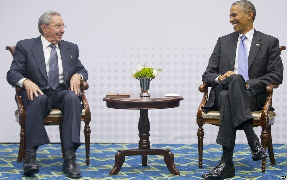 US President Barack Obama (R) smiles as he looks over towards Cuban President Raul Castro