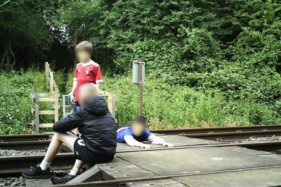 Children on level crossing in Wing