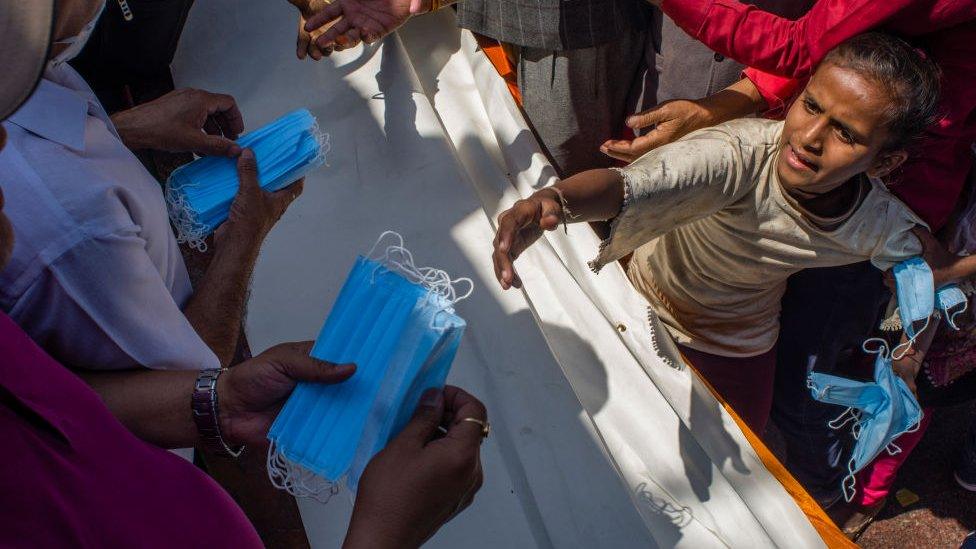 People distributing masks