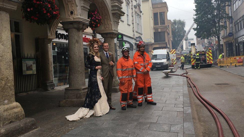 Nikki and Fraser Burling-Hobbs with firemen outside Guildhall