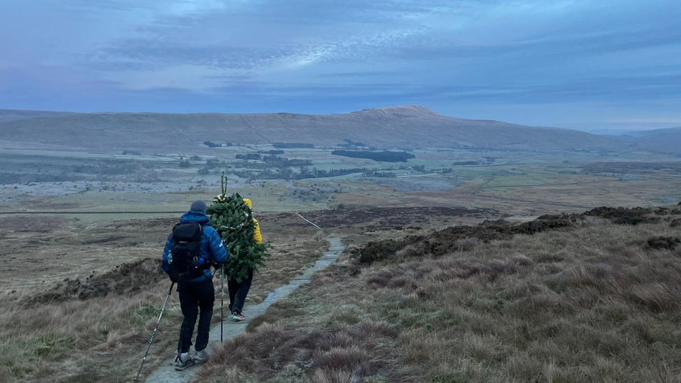 Ross Stirling and Ed Jackson climbing a mountain. You can see them from behind.