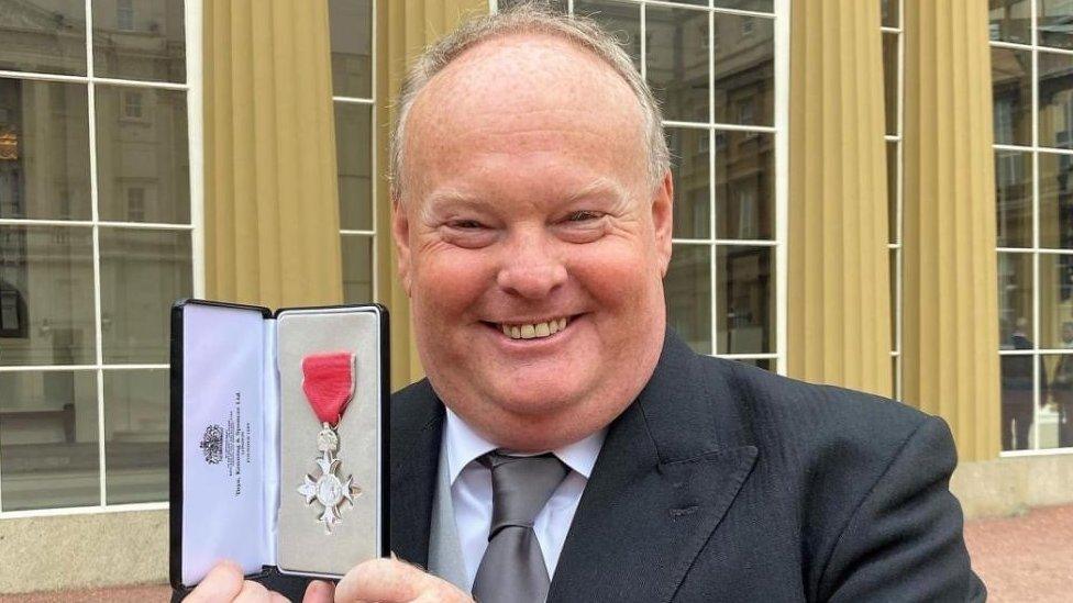 Mark Murphy at Buckingham Palace with his MBE