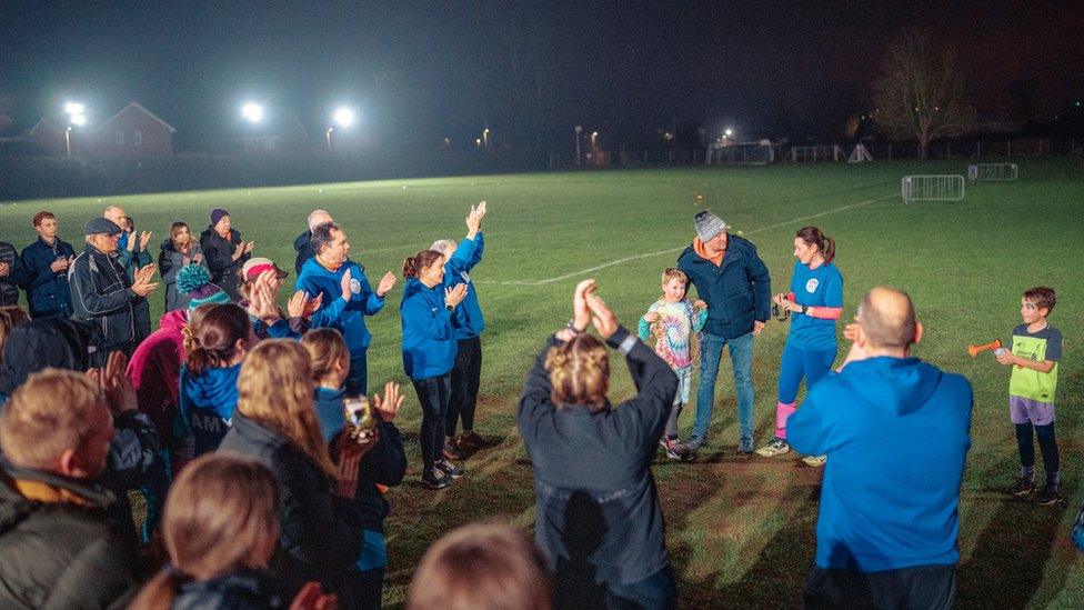 Members of the club congratulate the family at the end of the challenge