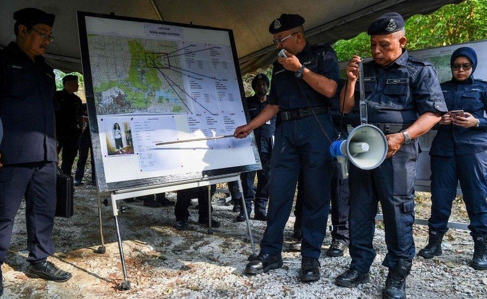 A Royal Malaysian Police officer conducts a briefing