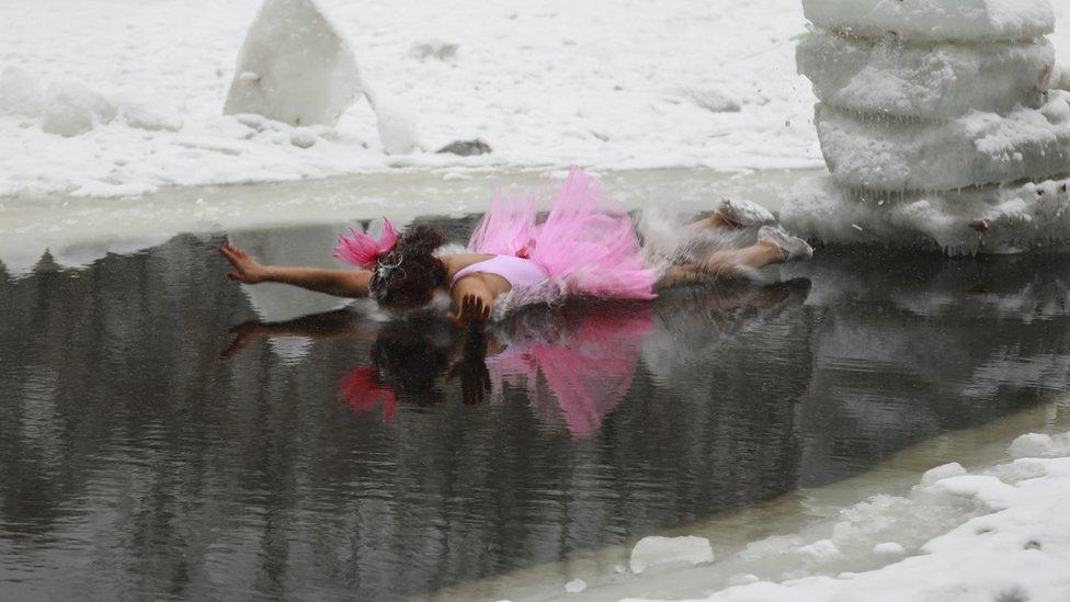 Woman in tutu face plants into water