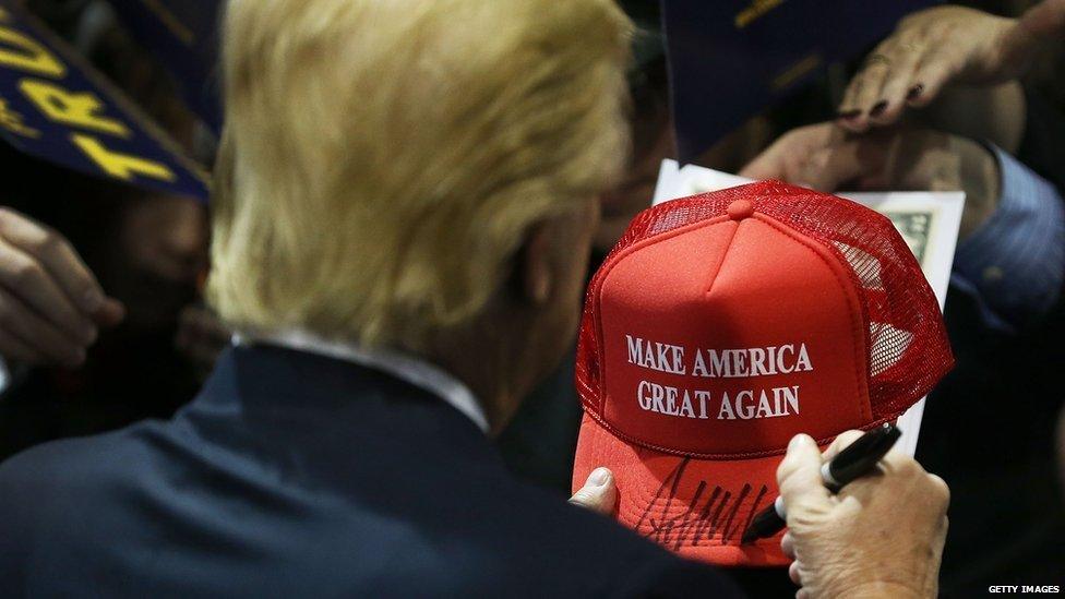 This is a photo of Donald Trump's campaign merchandise. The red hat reads, "Make America great again."