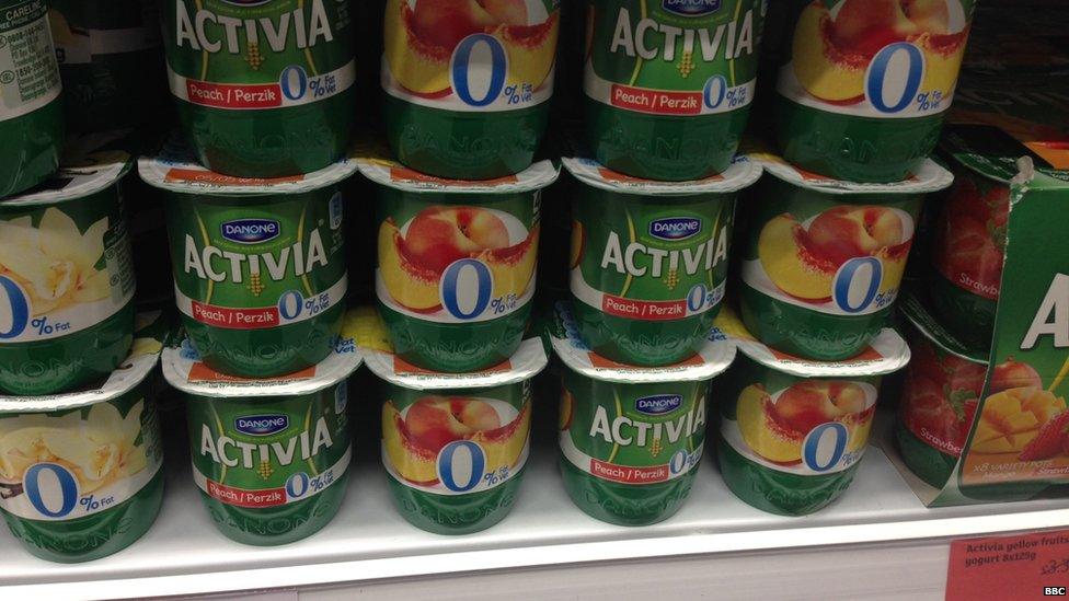 Activia peach yoghurt on supermarket shelf.