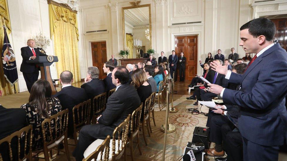 A reporter asks a question of Donald Trump.