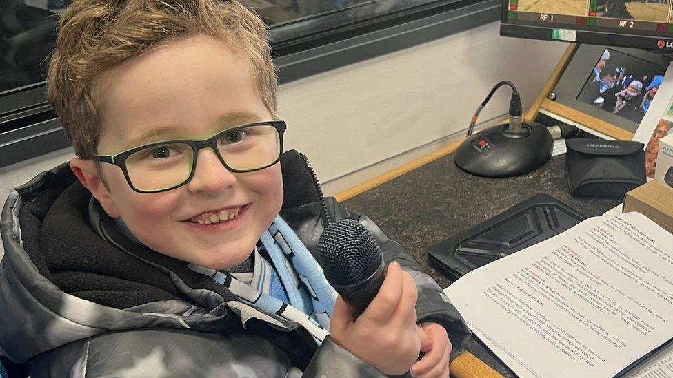 Manchester City fan Nate holding a microphone