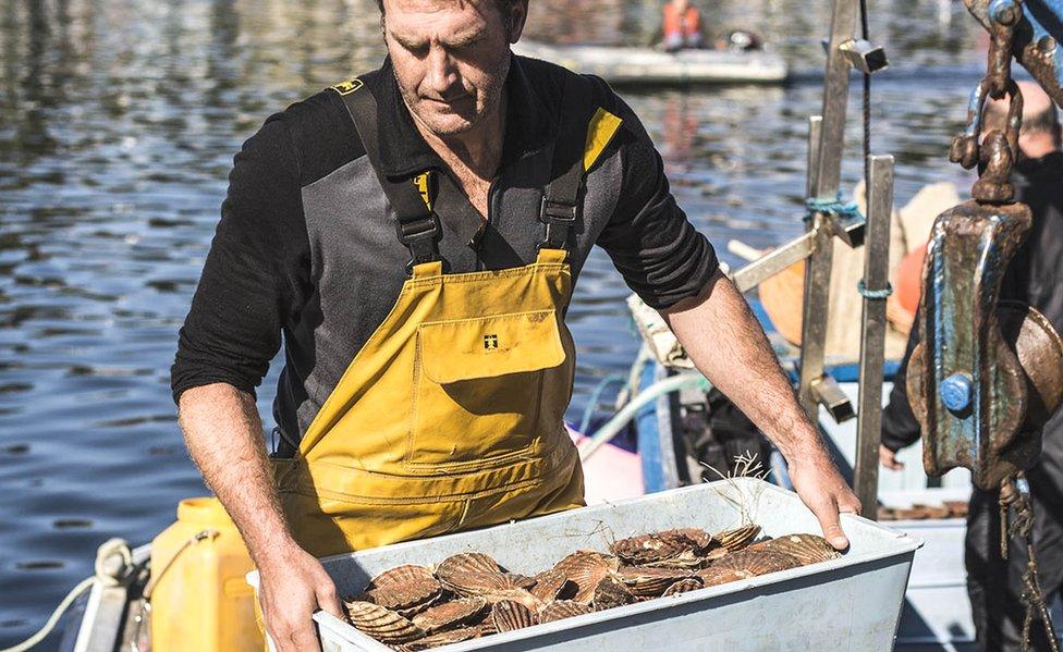 Man carrying box of shellfish