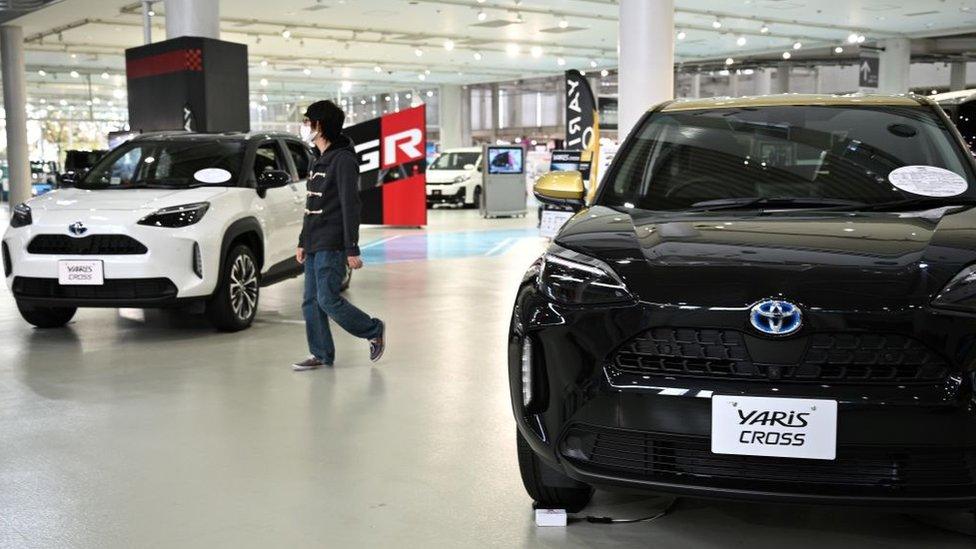 A person at a Toyota showroom in Tokyo.