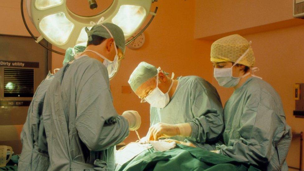 Surgeon and assistants at work during an operation