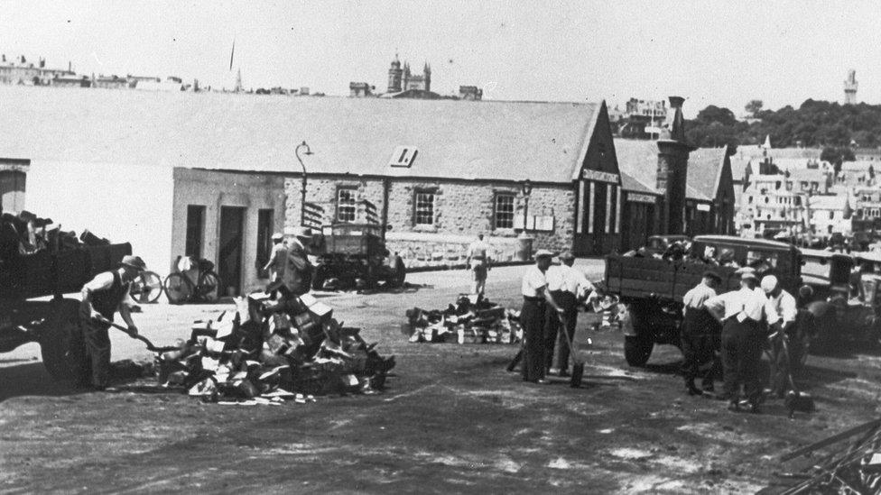 Men clearing up the streets of Guernsey