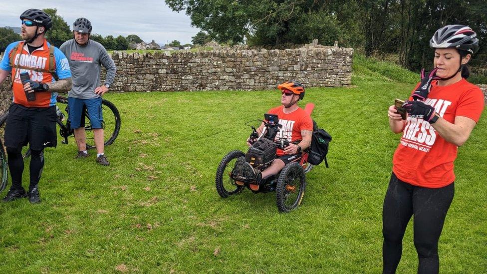 Four cyclists taking a break on grass