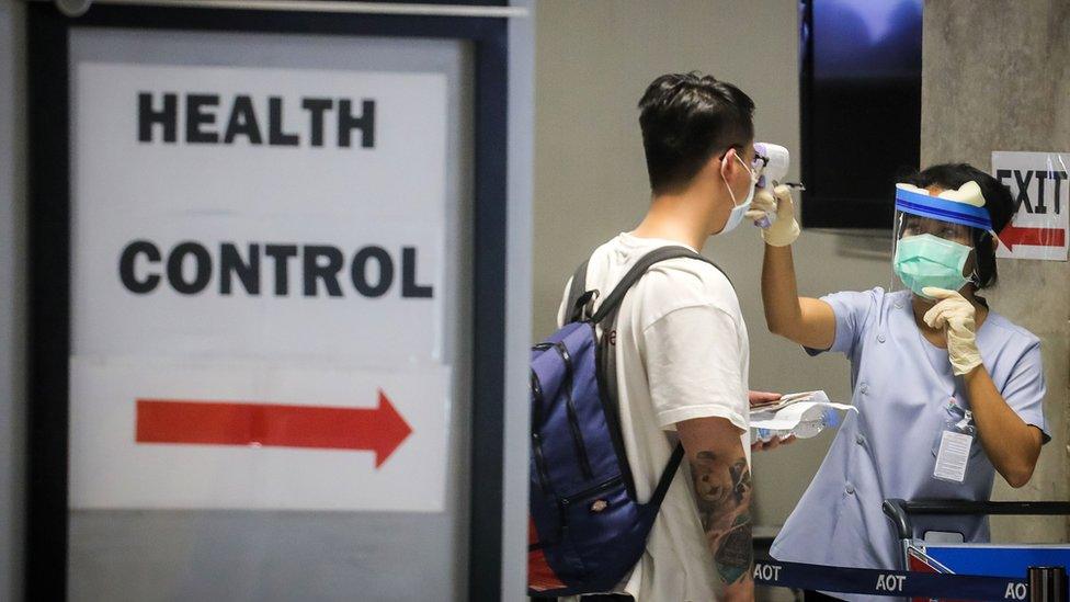 A traveller being tested upon arrival at Suvarnabhumi Airport in Bangkok on 9 March