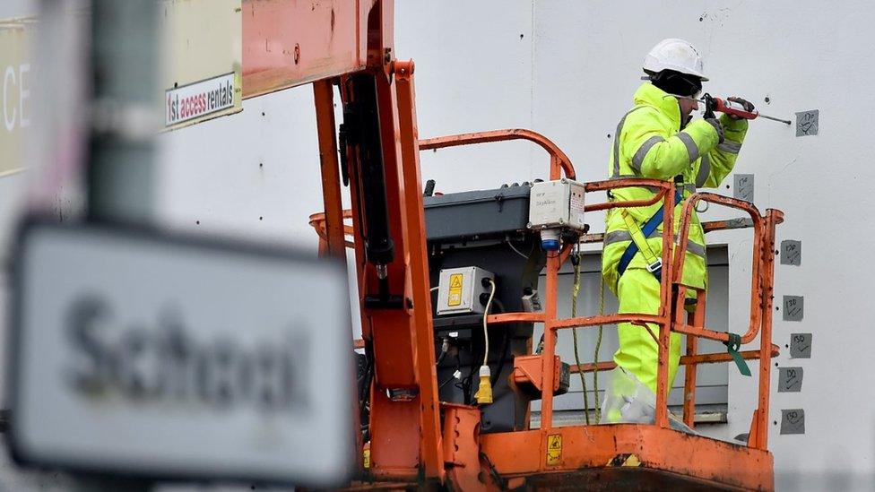 Worker carrying out repairs at Edinburgh school