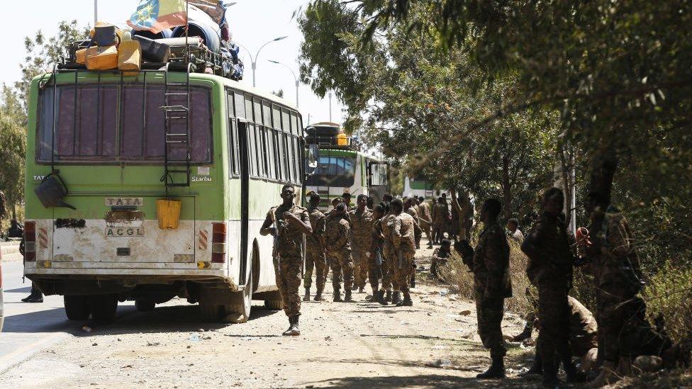 Soldiers on patrol on Mekelle on a road with buses, Ethiopia - March 2021